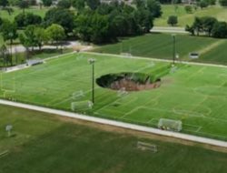 Video CCTV Stadion merekam momen ketika sebuah lubang selebar 100 kaki menelan lapangan Sepak Bola.